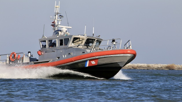 Stranded kite surfer rescued after writing HELP out of rocks in the sand